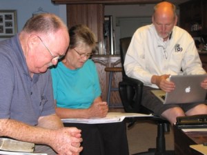 Paul (right) training Mary to lead Charles through prayer.